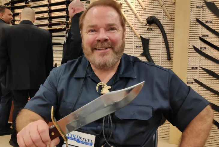 Lynn Thompson holding a large knife